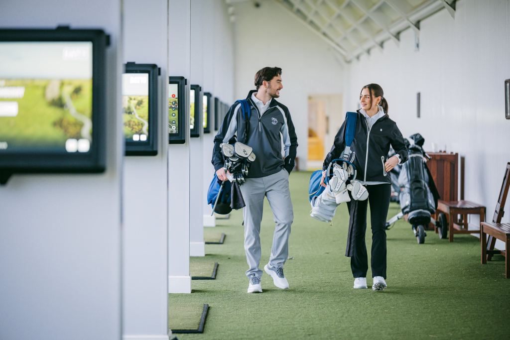 Two golfers walking together with their clubs