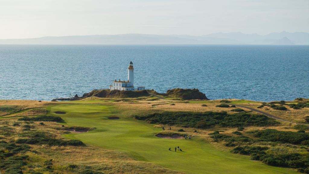 Golfers on a championship links beside the lighthouse