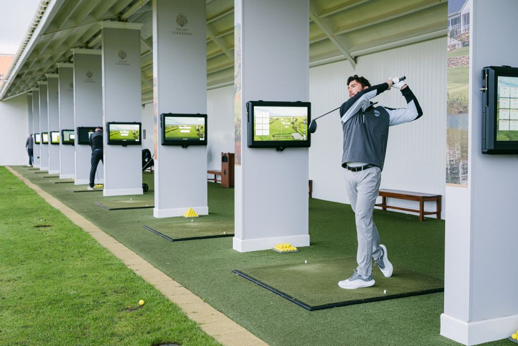 A golfer on a covered driving range