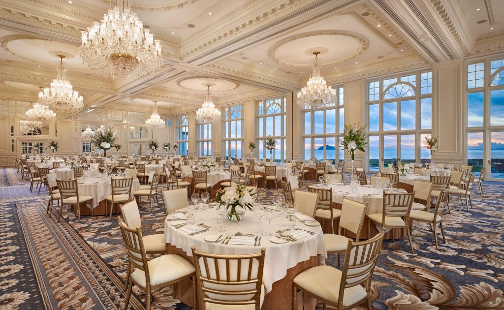 A ballroom laid for a formal dinner