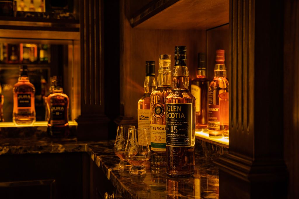 Single malt whiskies on a lit bar