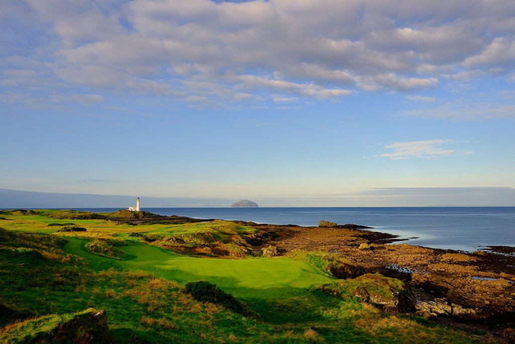 A links green on a rocky shoreline