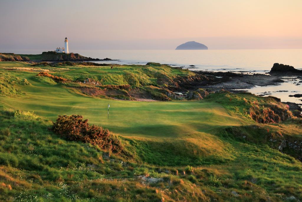 A links green by the sea at sunset