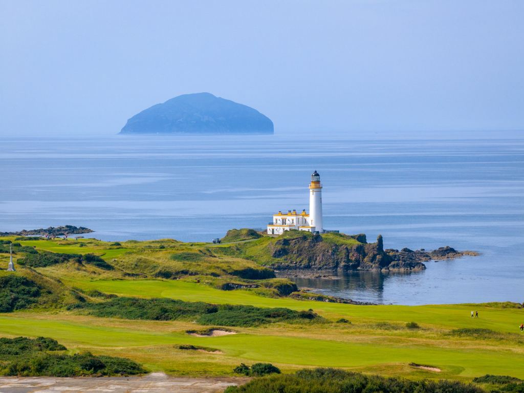 A lighthouse above the links with an island offshore